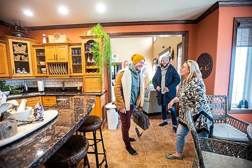 MIKAELA MACKENZIE / WINNIPEG FREE PRESS

Justin LeBlanc (left), Brett Sheffield, and Marilyn Pierce laugh in the kitchen of the mansion on the Castleview Developments property, a 104 acre lot on Pelican Lake, in Manitoba on Tuesday, Jan. 24, 2023. The new owners are planning on creating cabins, a wedding venue/corporate retreat, trails, and other amenities. Winnipeg Free Press 2023.