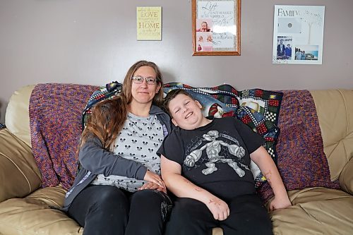 Meigan Oakley and her son Rylan, 11, at their home Monday afternoon. Oakley has been growing her hair for 10 years and cut her long locks off Monday to donate the cut hair to Wigs For Kids. (Tim Smith/The Brandon Sun)