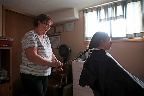 Iris Karton braids her daughter Meigan Oakley's hair Monday afternoon before it is shipped off to Wigs for Kids, an organization that uses donated hair to create wigs for children who've lost their own hair due to cancer treatment. (Tim Smith/The Brandon Sun)