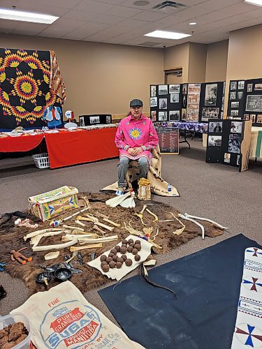 Sioux Valley Dakota Nation Elder and Knowledge Keeper Eugene Ross sits in front of traditional food and tools of the Dakota people on Wednesday at the “Oceti Sakowin icipes unkikcupte,” or Taking Back the Seven Sacred Council Fires gathering of elders and knowledge keepers held at the Keystone Centre in Brandon. (Miranda Leybourne/The Brandon Sun)