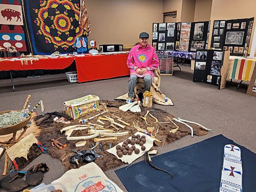 Sioux Valley Dakota Nation Elder and Knowledge Keeper Eugene Ross sits in front of traditional food and tools of the Dakota people on Wednesday at the “Oceti Sakowin icipes unkikcupte,” or Taking Back the Seven Sacred Council Fires gathering of elders and knowledge keepers held at the Keystone Centre in Brandon. (Miranda Leybourne/The Brandon Sun)