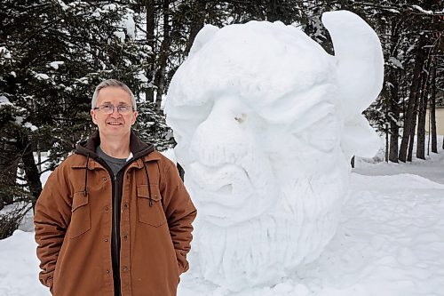 25012023
George Hartlen with Friends of Riding Mountain National Park stands with a snow sculpture of a bison in front of the FRMNP office in Wasagaming on a mild Wednesday afternoon. A variety of snow sculptures dot the town. 
(Tim Smith/The Brandon Sun)