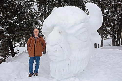 George Hartlen with Friends of Riding Mountain National Park stands with a snow sculpture of a bison in front of the FRMNP office in Wasagaming last month. A variety of snow sculptures dot the town. (Tim Smith/The Brandon Sun)