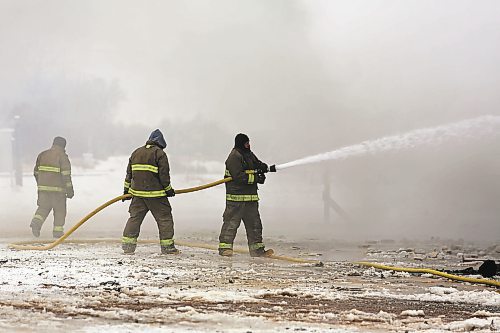 Firefighters let loose a stream of water at the embers of the Gladstone Hotel fire on Christmas Day. The Office of the Fire Commissioner is still investigating the cause of that fire and one that claimed the life of a 68-year-old man in Neepawa on Jan. 19. (Colin Slark/The Brandon Sun)