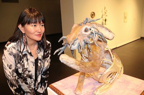 Emily Jan checks in on one of the wool jackalopes that she put together for her "Kali Yuga" exhibition, which opened at the Art Gallery of Southwestern Manitoba this past Thursday. The "horns" protruding from the jackalope is a reference to the Shope papilloma virus that causes similar growths to occur on certain leporids in the wild. (Kyle Darbyson/The Brandon Sun)