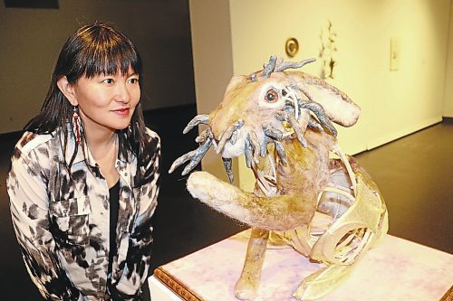 Emily Jan checks in on one of the wool jackalopes that she put together for her "Kali Yuga" exhibition, which opened at the Art Gallery of Southwestern Manitoba this past Thursday. The "horns" protruding from the jackalope is a reference to the Shope papilloma virus that causes similar growths to occur on certain leporids in the wild. (Kyle Darbyson/The Brandon Sun)