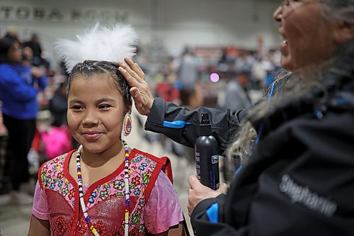 Stephanie Bird (right) of Wahpeton Dakota Nation helps Charlotte Bird with her hair as Charlotte prepares for the powwow grand entry on the opening evening of the Dakota Nation Winterfest at the Keystone Centre on Friday evening. (Tim Smith/The Brandon Sun)