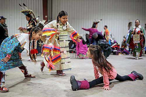 Meeka Hall, Jovi Keewatin and Kaylor Halfe dance and perform gymnastics while waiting for the powwow grand entry to commence on the opening evening of the Dakota Nation Winterfest at the Keystone Centre on Friday evening. After cancellations in 2021 and 2022 due to the COVID-19 pandemic, the annual event is back in the wheat city until Sunday and features a powwow, a talent show, hockey, volleyball and basketball tournaments, and much more. (Tim Smith/The Brandon Sun)