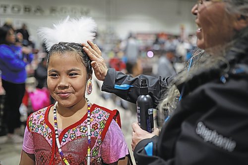 27012022
Stephanie Bird (R) of Wahpeton Dakota Nation helps Charlotte Bird with her hair as Charlotte prepares for the powwow grand entry on the opening evening of the Dakota Nation Winterfest at the Keystone Centre on Friday evening. After cancellations in 2021 and 2022 due to the COVID-19 pandemic, the annual event is back in the wheat city until Sunday and features a powwow, a talent show, hockey, volleyball and basketball tournaments, and much more. 
(Tim Smith/The Brandon Sun)