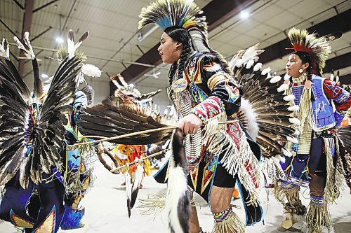 27012022
Dancers take part in the powwow grand entry at the Dakota Nation Winterfest at the Keystone Centre on Friday evening. After cancellations in 2021 and 2022 due to the COVID-19 pandemic, the annual event is back in the wheat city until Sunday and features a powwow, a talent show, hockey, volleyball and basketball tournaments, and much more. 
(Tim Smith/The Brandon Sun)