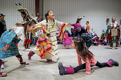 27012022
Meeka Hall, Jovi Keewatin and Kaylor Halfe dance and perform gymnastics while waiting for the powwow grand entry to commence on the opening evening of the Dakota Nation Winterfest at the Keystone Centre on Friday evening. After cancellations in 2021 and 2022 due to the COVID-19 pandemic, the annual event is back in the wheat city until Sunday and features a powwow, a talent show, hockey, volleyball and basketball tournaments, and much more. 
(Tim Smith/The Brandon Sun)