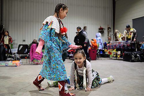 27012022
Meeka Hall taps Sophia Halfe on the head while Sophia does the splits while waiting for the powwow grand entry to commence on the opening evening of the Dakota Nation Winterfest at the Keystone Centre on Friday evening. After cancellations in 2021 and 2022 due to the COVID-19 pandemic, the annual event is back in the wheat city until Sunday and features a powwow, a talent show, hockey, volleyball and basketball tournaments, and much more. 
(Tim Smith/The Brandon Sun)