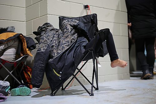 27012022
A visitor to the Dakota Nation Winterfest relaxes under a coat during the powwow on the opening evening at the Keystone Centre on Friday. After cancellations in 2021 and 2022 due to the COVID-19 pandemic, the annual event is back in the wheat city until Sunday and features a powwow, a talent show, hockey, volleyball and basketball tournaments, and much more. 
(Tim Smith/The Brandon Sun)