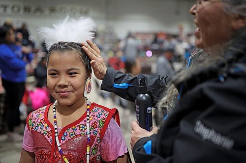 27012022
Stephanie Bird (R) of Wahpeton Dakota Nation helps Charlotte Bird with her hair as Charlotte prepares for the powwow grand entry on the opening evening of the Dakota Nation Winterfest at the Keystone Centre on Friday evening. After cancellations in 2021 and 2022 due to the COVID-19 pandemic, the annual event is back in the wheat city until Sunday and features a powwow, a talent show, hockey, volleyball and basketball tournaments, and much more. 
(Tim Smith/The Brandon Sun)