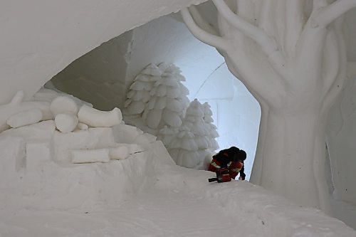 TYLER SEARLE / WINNIPEG FREE PRESS
The maze measures nearly 60,000 square feet and contains five buildings constructed from snow. The interior of each building features snow carvings and sculptures. On on Saturday, Feb. 28, 2023, a staff member was working inside.