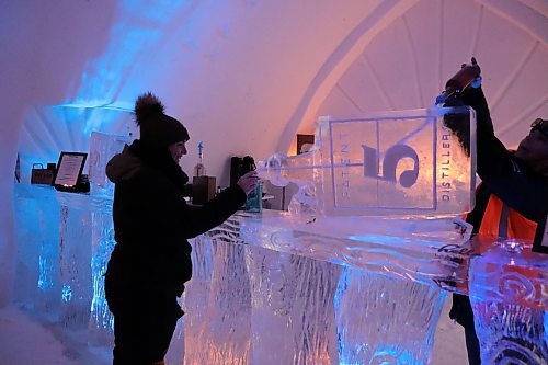 TYLER SEARLE / WINNIPEG FREE PRESS
Amélie Métail, 26, was the first customer to order a drink from the ice bar. She came to experience the snow maze with three of her friends on Saturday, Feb. 28, 2023.