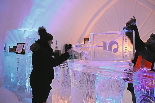 TYLER SEARLE / WINNIPEG FREE PRESS
Amélie Métail, 26, was the first customer to order a drink from the ice bar. She came to experience the snow maze with three of her friends on Saturday, Feb. 28, 2023.