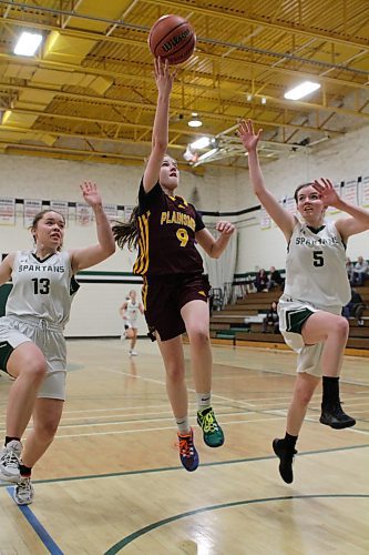 Crocus Plainsmen guard Kylie Kulman tries a layup while Neelin Spartans Beth Wilson (13) and Rachel McCausland defend during the NIT varsity girls' basketball tournament final on Saturday. (Thomas Friesen/The Brandon Sun)