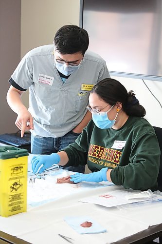 Dr. Adrian Fung instructs University of Manitoba medical student Claire Risbey on how to properly suture a wound Saturday afternoon at the Brandon Regional Health Centre. Risbey is one of 34 Rural Interest Group students from the U of M who visited the BRHC this past Friday and Saturday to learn what it's like to work at a remote medical facility. (Kyle Darbyson/The Brandon Sun)