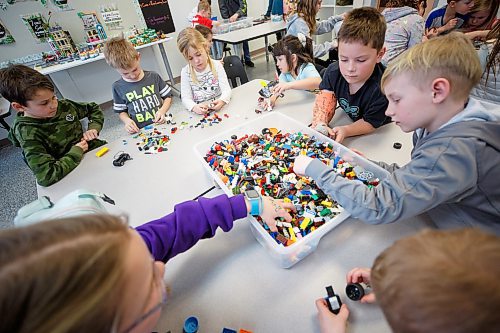 MIKE DEAL / WINNIPEG FREE PRESS
Starbuck School students playing with lego during the noon-hour Lego Club, (clockwise from bottom left) Jaidyn Smart, Wayne Marks, Bentley Manaigre, Taylor Harding, Lily Turner, Cale Schrof, and Ryker Milne.
Tim Morison, phys-ed teacher at Starbuck School in Starbuck, MB, found in Lego an unlikely cure to workplace burnout and mental health challenges, which began after months of teaching during a pandemic and worsened when he and his wife lost their baby in the spring. Morison opened up to his students about his mental health struggles and shared his coping mechanism: building Lego with his three-year-old at home and alone, with them. His studentsՠreceptiveness has since sparked the launch of a Lego club at Starbuck School. On Mondays and Tuesdays, the phys-ed teacher forfeits his lunch hour to spend time with K-8 students and colourful blocks. Theyնe done significant fundraising to purchase toys and accepted donations from community members.
See Maggie Macintosh story
230130 - Monday, January 30, 2023.