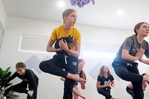 30012023
Adi Henwood holds a kitten and a pose while taking part in a yoga glass with teammates from her U13 AA female Wheat Kings team during Caturday kitten yoga at Luna Muna yoga and wellness studio in Brandon on Saturday. 
(Tim Smith/The Brandon Sun)
