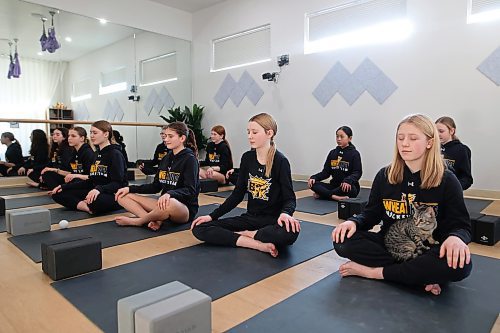 30012023
A kitten sits on Brynn Rice&#x2019;s lap as Rice and teammates from the U13 AA female Wheat Kings take part in Caturday kitten yoga at Luna Muna yoga and wellness studio in Brandon on Saturday. 
(Tim Smith/The Brandon Sun)