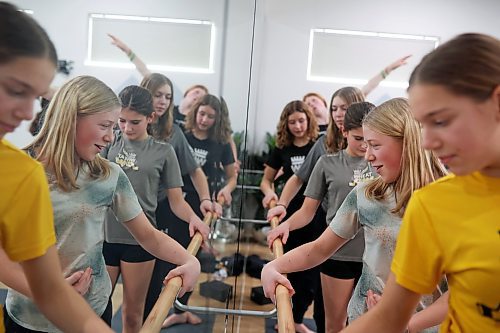 30012023
Hockey players from the U13 AA female Wheat Kings are reflected in a mirror while striking a ballet pose after taking part in Caturday kitten yoga at Luna Muna yoga and wellness studio in Brandon on Saturday. 
(Tim Smith/The Brandon Sun)