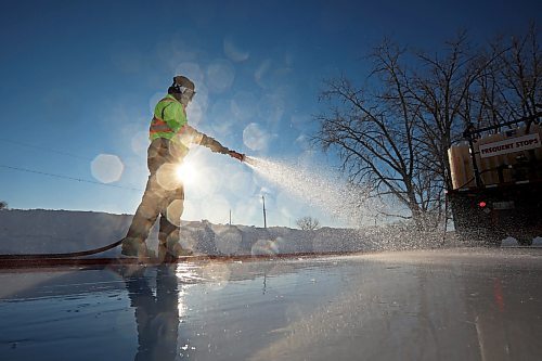 30012023
Abigail Longman with the City of Brandon Parks &amp; Recreation department floods the Brandon Skating Oval with water as part of maintenance for the skating rink while her coworker Chris Murphy drives the water truck on a bitterly cold Monday afternoon. 
(Tim Smith/The Brandon Sun)