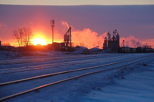Rail lines for the Canadian National Railway along Russell Street glow in the morning sunrise on Tuesday in Brandon. (Matt Goerzen/The Brandon Sun)
