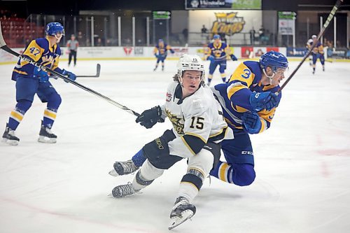 31012022
Nolan Ritchie #15 of the Brandon Wheat Kings and Blake Gustafson #3 of the Saskatoon Blades get tangled up during WHL action at Westoba Place on Tuesday evening. 
(Tim Smith/The Brandon Sun)
