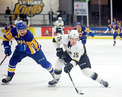31012022
Nolan Ritchie #15 of the Brandon Wheat Kings plays the up ice with Blake Gustafson #3 of the Saskatoon Blades in hot pursuit during WHL action at Westoba Place on Tuesday evening. 
(Tim Smith/The Brandon Sun)