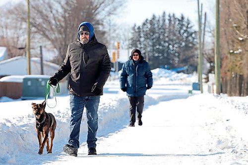 01022023
Scott Olderburger walks his dog Lizzy along the walking path bordering the Brandon Municipal Cemetery on a cold Wednesday afternoon. 
(Tim Smith/The Brandon Sun)