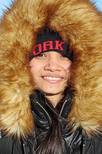 Vini (no last name given) waits for a bus along 18th Street while bundled up in a thick jacket on a chilly day earlier this month. (Tim Smith/The Brandon Sun)