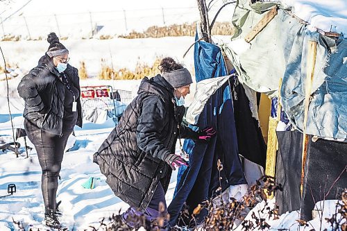 MIKAELA MACKENZIE / WINNIPEG FREE PRESS

Case worker Robin Eastman checks to see if anyone is around at a camp to offer sandwiches, warm socks, water, and other supplies from the Main Street Project van in Winnipeg on Wednesday, Feb. 1, 2023. For Tyler story.

Winnipeg Free Press 2023.