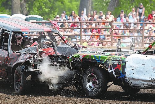 Brandon Sun Two cars collide heat on forcing stream from the radiators during the third heat at the Demolition Derby held at the Manitoba Summer Fair on Sunday. (Bruce Bumstead/Brandon Sun)