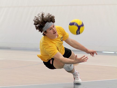 Jens Watt dives for a ball during Brandon University men's volleyball practice on Thursday. (Thomas Friesen/The Brandon Sun)