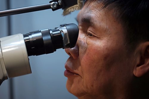 02022023
Dat Tao, owner of TCM Goldsmith on Rosser Avenue in downtown Brandon, looks through a magnifier while working on repairing a ring in his workshop. (Tim Smith/The Brandon Sun)
