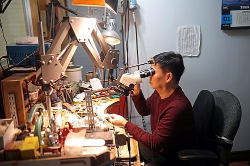 02022023
Dat Tao, owner of TCM Goldsmith on Rosser Avenue in downtown Brandon, looks through a magnifier while working on repairing a ring in his workshop. (Tim Smith/The Brandon Sun)
