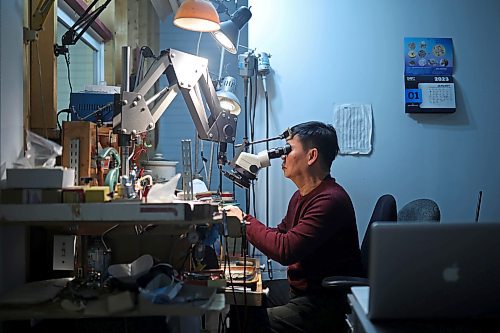 02022023
Dat Tao, owner of TCM Goldsmith on Rosser Avenue in downtown Brandon, looks through a magnifier while working on repairing a ring in his workshop. (Tim Smith/The Brandon Sun)
