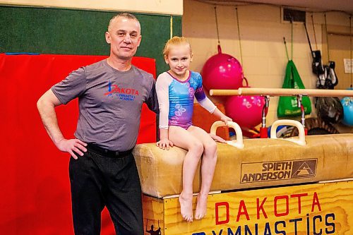 MIKAELA MACKENZIE / WINNIPEG FREE PRESS

Six-year-old Anastasia Rezmikova poses for a photo with her coach, Adik Isakov, at Dakota Gymnastics Academy in Winnipeg on Tuesday, Jan. 31, 2023. Anastasia won gold at a gymnastics competition in Brandon last weekend. It&#x573; been a long journey for her both in gymnastics and life - with her mother and sister, they fled Ukraine last year. For Kevin story.

Winnipeg Free Press 2023.