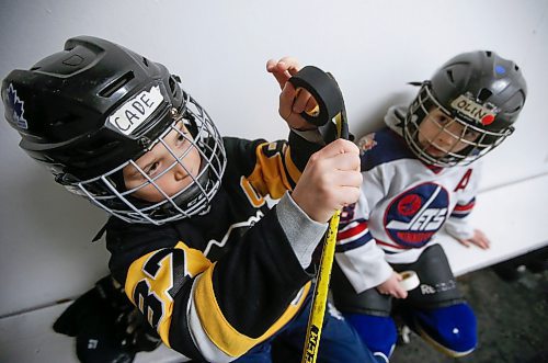 JOHN WOODS / WINNIPEG FREE PRESS
Cade, 8, and Olin Andrew, 7, right, tape their sticks before they hit the ice for hockey practice at Deer Lodge Community Centre Tuesday, January 17, 2023. 

Re: sanderson