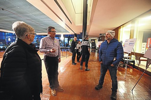 The City of Brandon's director of engineering services, Mark Allard (left), talks to Tristan Lepischak (right) at n open house for the southwest lift station project on Tuesday. (Colin Slark/The Brandon Sun)