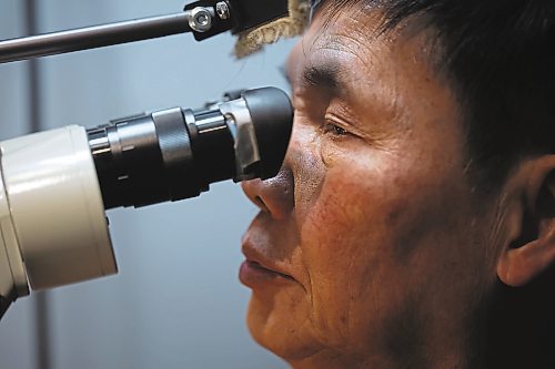 02022023
Dat Tao, owner of TCM Goldsmith on Rosser Avenue in downtown Brandon, looks through a magnifier while working on repairing a ring in his workshop. (Tim Smith/The Brandon Sun)
