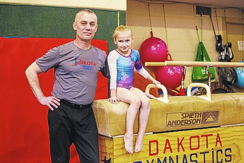 MIKAELA MACKENZIE / WINNIPEG FREE PRESS

Six-year-old Anastasia Rezmikova poses for a photo with her coach, Adik Isakov, at Dakota Gymnastics Academy in Winnipeg on Tuesday, Jan. 31, 2023. Anastasia won gold at a gymnastics competition in Brandon last weekend. It&#x573; been a long journey for her both in gymnastics and life - with her mother and sister, they fled Ukraine last year. For Kevin story.

Winnipeg Free Press 2023.