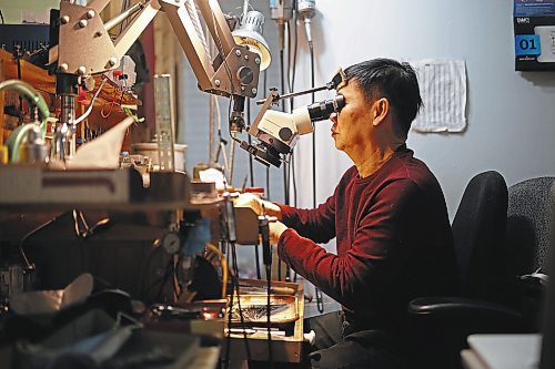 02022023
Dat Tao, owner of TCM Goldsmith on Rosser Avenue in downtown Brandon, looks through a magnifier while working on repairing a ring in his workshop. (Tim Smith/The Brandon Sun)
