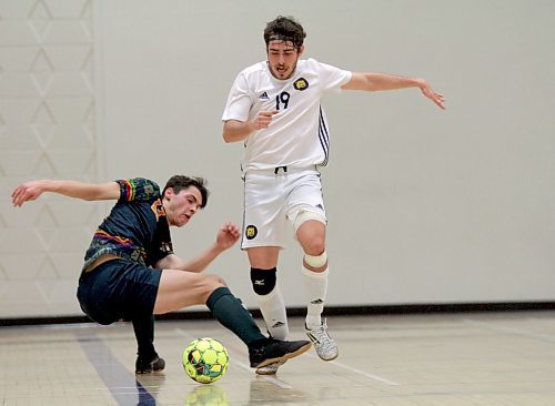 Matheus Ruffini of the Brandon Bobcats breaks Canadian Mennonite University's Michael Pahl's tackle during their MCAC men's futsal game at Henry Champ Gymnasium on Saturday. (Thomas Friesen/The Brandon Sun)