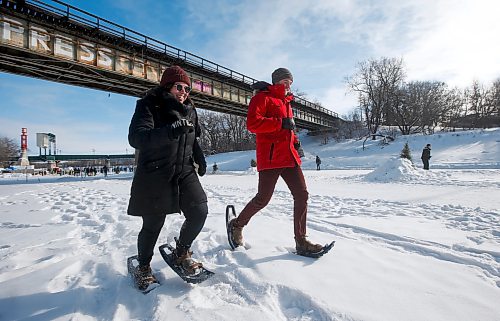 JOHN WOODS / WINNIPEG FREE PRESS
Ariel Desrochers, sustainable transporation coordinator with Green Action Centre (GAC), left, and Sean Birkett, sustainability projects assistant at GAC, jog in snowshoes  at the kickoff of the 12th annual Jack Frost Challenge at the Forks Sunday, February 5, 2023. Participants pledge to do 130 kms of winter activity in the week long challenge.