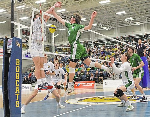 Saskatchewan Huskies left side Isaiah Mamer beats Brandon Bobcats setter JJ Love's block in their Canada West men's volleyball match at the Healthy Living Centre on Saturday. (Thomas Friesen/The Brandon Sun)