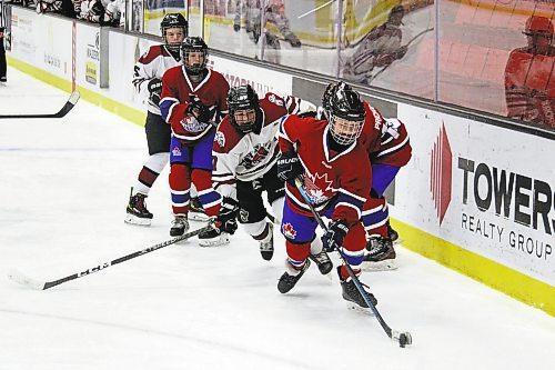 Easton Pitz of the Virden Jr. Oil Caps chases after Hudson Hughes of the St. James Canadians during a Tournament of Champions U13 AA game at Westoba Place Saturday. (Lucas Punkari/The Brandon Sun)