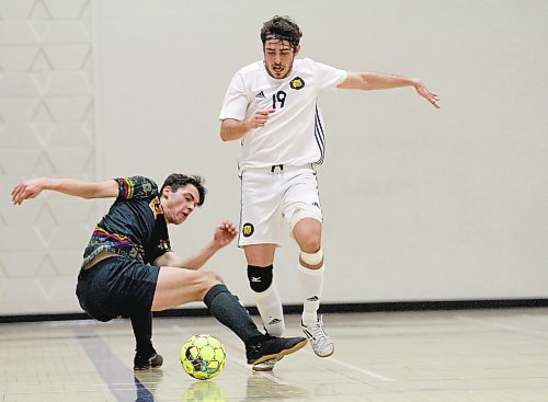 Matheus Ruffini of the Brandon Bobcats breaks Canadian Mennonite University's Michael Pahl's tackle during their MCAC men's futsal game at Henry Champ Gymnasium on Saturday. (Thomas Friesen/The Brandon Sun)